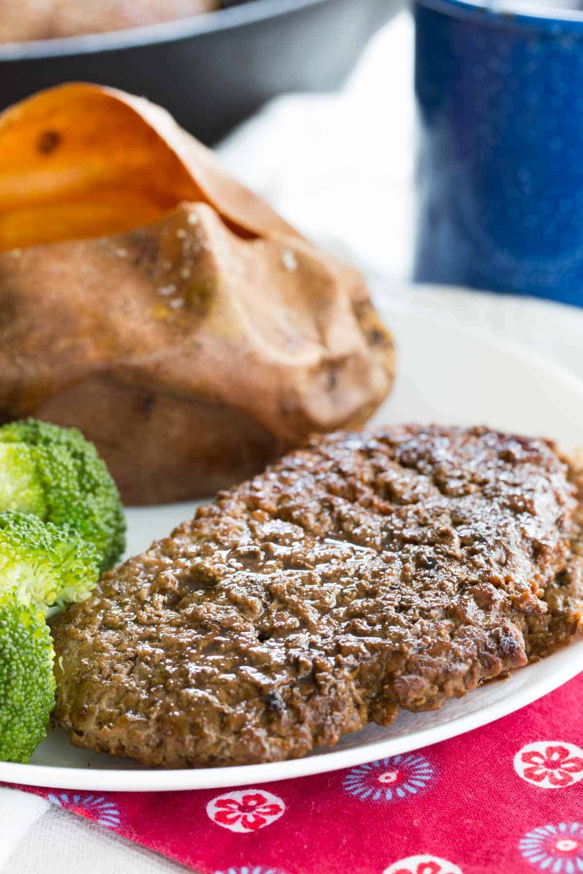 This easy cube steak recipe is ready in under 10 minutes and only needs a few simple ingredients. Make tender, juicy steak in no time! Pan seared cube steak on a plate with side dishes.