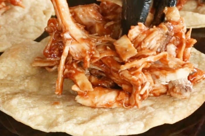 Pile shredded barbecue chicken on top of tostada shells