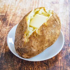 a fluffy baked potato with a pat of butter inside